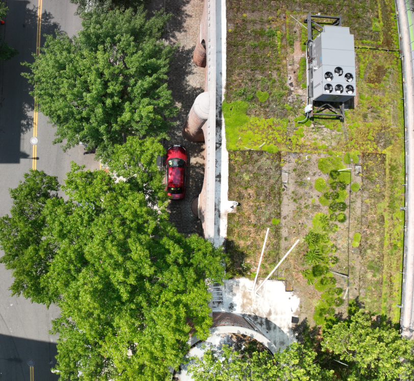 Image of the top of the roof and street from the view of the drone